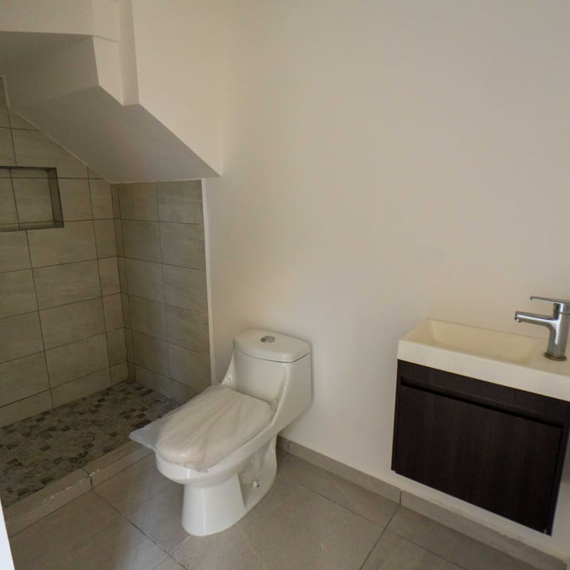 Baño completo con cancel de cristal y lavabo en modelo Málaga